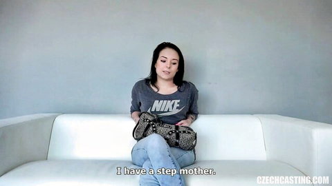 Skinny brunette teen in Nike shirt and jeans sits on casting couch during Czech audition