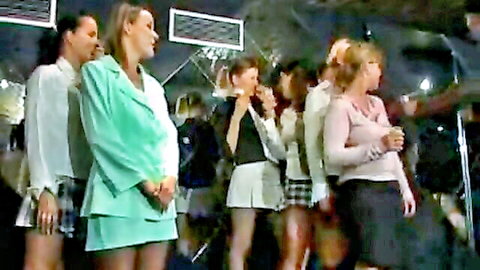 Group of sexy schoolgirls in short plaid skirts and blouses posing together teasingly