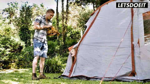 Cheating skinny wife peeks from tent as lover approaches outdoors