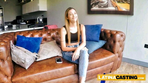 Smiling small tits blonde teen in casual top and jeans on Latina casting couch