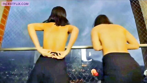 Reyes Twins topless from behind on balcony, bare backs and skirts