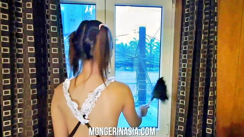 Sexy young brunette Asian maid in backless lace outfit bends over dusting window from behind