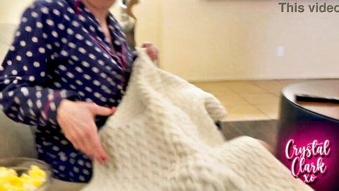 Crystal Clark stepmom in polka-dot blouse holding fluffy blanket for movie night tease
