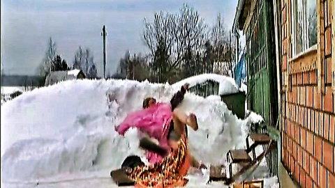 Two Russian women playfully tumbling in snowy outdoors, exposing bare asses