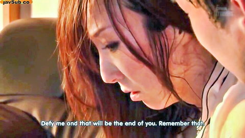 Intense close-up of Japanese MILF threatening man in car with dominant glare in JAV scene