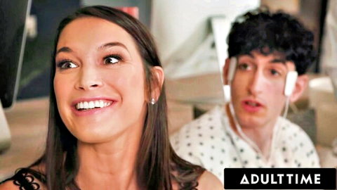 Smiling brunette woman looks at camera with young curly-haired guy behind her in AdultTime scene