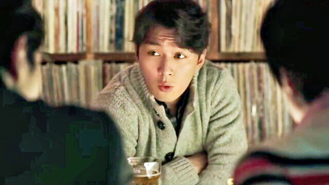 Korean man in cardigan surprised chatting with friends in record store romantic scene