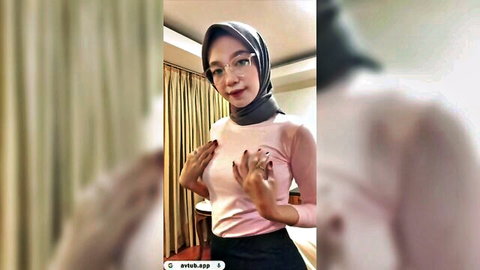 Petite Indonesian hijab babe in glasses squeezing her small tits through tight pink top