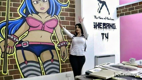 Candy Sexton poses in Shebang.TV new studios with sexy anime mural
