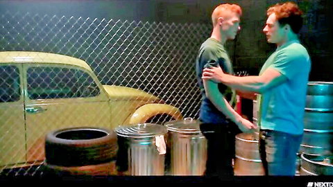 Red-haired straight guy embraced by muscular gay friend in intimate Next Door Studios scene