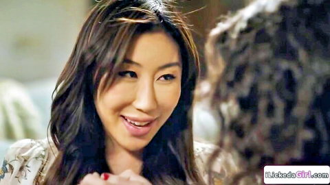 Asian lesbian girlfriends smiling intimately close-up before kissing