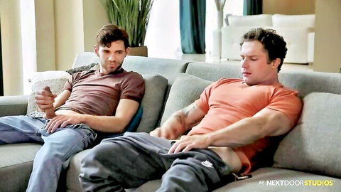 Two muscular gay studs groping their bulging cocks through pants on couch