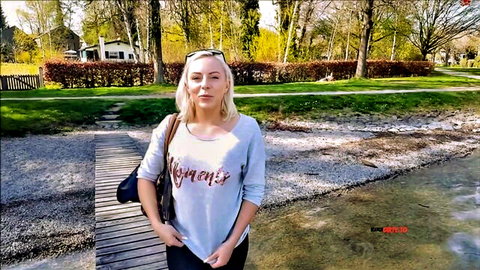 Lilli Vanilli outdoors in gray sweater and jeans by the water