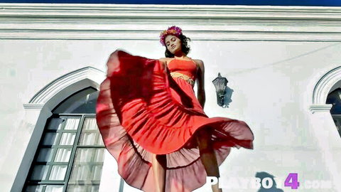 Sensual Indian model twirls red flared dress outdoors teasing long legs and curves