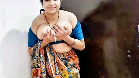 Busty Indian woman squeezing her huge bare tits exposed from blue blouse in colorful saree