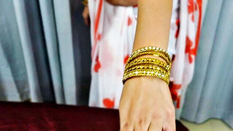 Sexy Indian aunty in white saree showing gold bangles on arm
