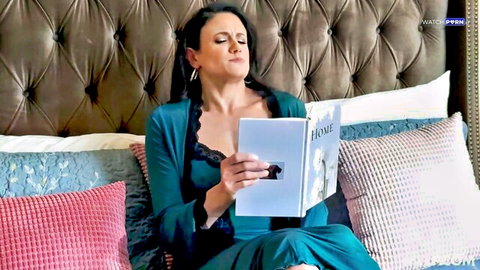 Penny Barber in teal lingerie reading book seductively