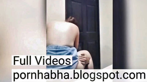Indonesian woman bare back view, blue jeans pulled down around thighs