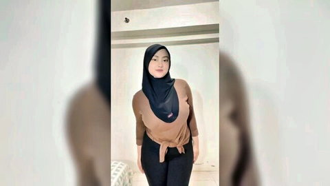 Curvy Asian woman in hijab showing deep cleavage in tight brown top