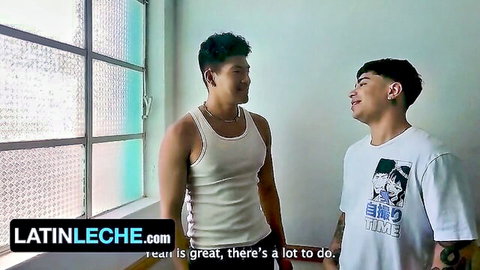 Two muscular studs in tank top and anime shirt smiling seductively close together
