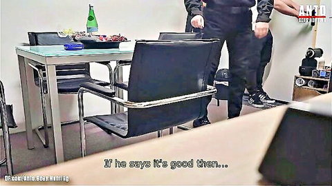 Two clothed men standing by glass table with food and drinks discussing if it's good in casual room