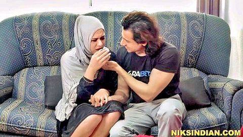 Indian hijabi woman emotional with stepbrother in intimate couch moment