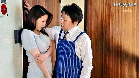 Japanese MILF in gray dress seduced by man in apron against door, JAV friend's mom scene