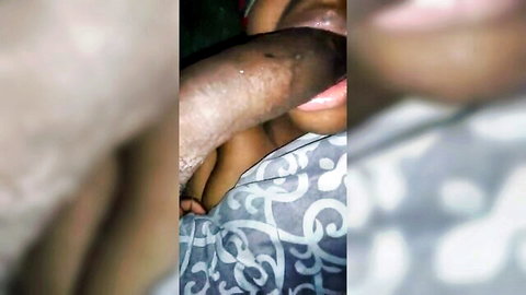 Ebony woman giving intense blowjob in close-up