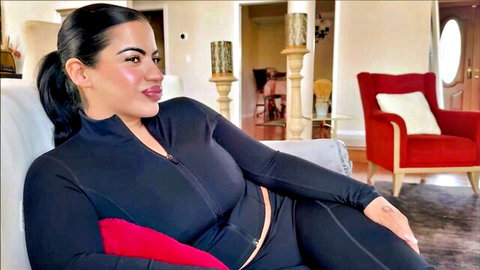 Lissa Aires thick Latina in tight black tracksuit, seductive couch pose
