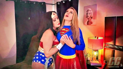 Wonder Woman embraces Supergirl in tight superhero cosplay hug