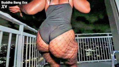 Chocolate Bunny teasing big ebony ass in fishnet bodysuit on balcony