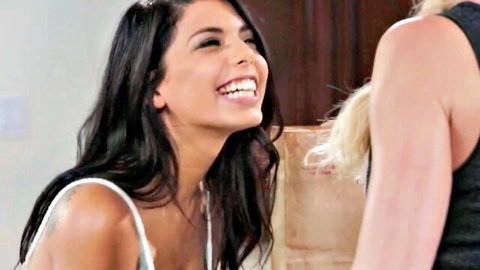 Tanned brunette petite with small tits smiles happily during lesbian tease with blonde MILF