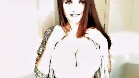 Busty redhead squeezes her massive tits together showing deep cleavage in sparkly top