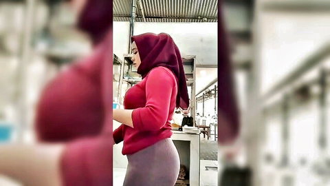 Indonesian hijab woman in tight pants teasing huge round ass in kitchen