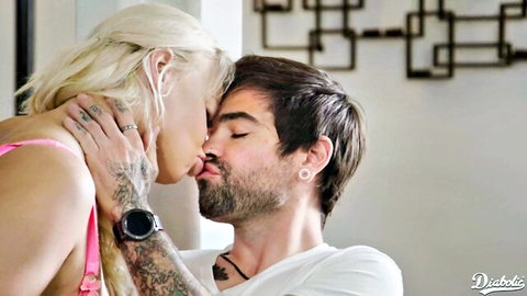 Tattooed blonde in pink lingerie passionately kissing bearded hunk