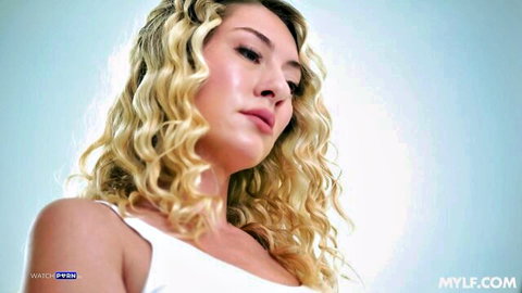 Rachael Cavalli blonde MILF in white tank top, curly hair side profile