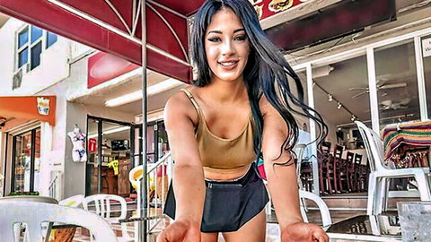 Kosame Dash smiling in tank top and mini skirt outdoors