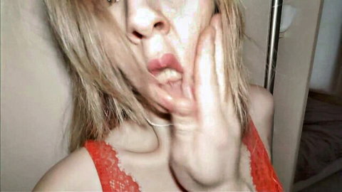 Blonde MILF stepmom in red lace lingerie, tongue out playfully