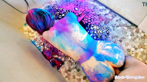 Colorful body paint on curvy woman in doggy pose, hand grabbing ass, explicit nude