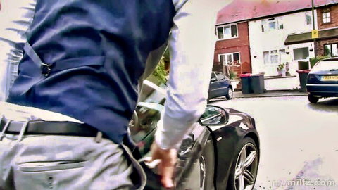 Man in suit leans into car window, teasing hungry milf wife on street