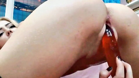 Blonde camgirl with big ass inserts orange dildo deep into wet shaved pussy solo