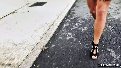 Ophelie 46yo in strappy black high heels and short dress walking on wet street