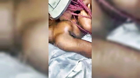Real African couple in hot foreplay, black woman with braids and curves enjoying intimate touch