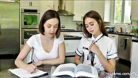 Brunette MILF in tank top tutors petite teen schoolgirl reading book at kitchen table