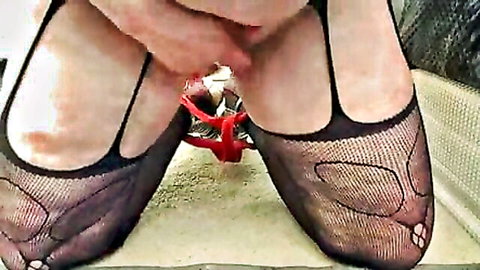 Dawn in torn fishnet stockings and red heels teasing crotch with hand
