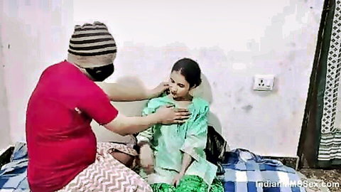 Indian couple in sensual foreplay, man caressing woman's neck in green salwar