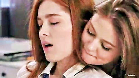 Redhead and brunette college girls in passionate dorm room embrace