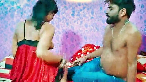 Sexy Indian wife in red dress seduced by shirtless bearded husband on bed