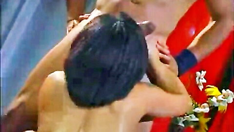 Marlie Moore and Angelica Saint in intimate lesbian embrace, red lingerie