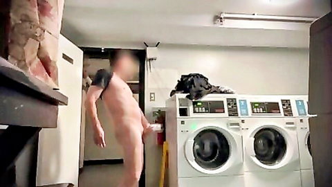 Naked man bends over exposing cock and balls in public laundromat near washers